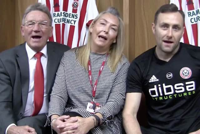 Sheffield United legend Tony Currie - far left - singing and swaying along to the track