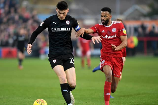 Barnsley's Kieffer Moore takes on Accrington's Michael Ihiekwe. Picture : Jonathan Gawthorp