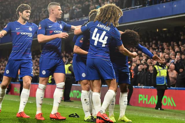 Projectiles including a coin and swimming goggles are thrown at Chelsea's Brazilian midfielder Willian.  (GLYN KIRK/AFP/Getty Images)