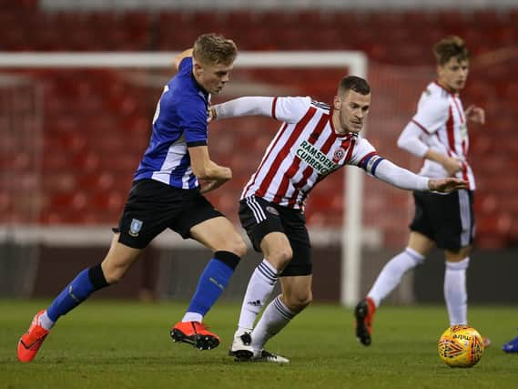 Jack Lee of Sheffield Wednesday tackles Paul Coutts of Sheffield Utd during the Professional Development League North match at Bramall Lane Stadium, Sheffield. James Wilson/Sportimage