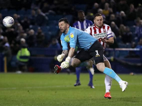 Billy Sharp and Keiren Westwood clash during the Steel City derby