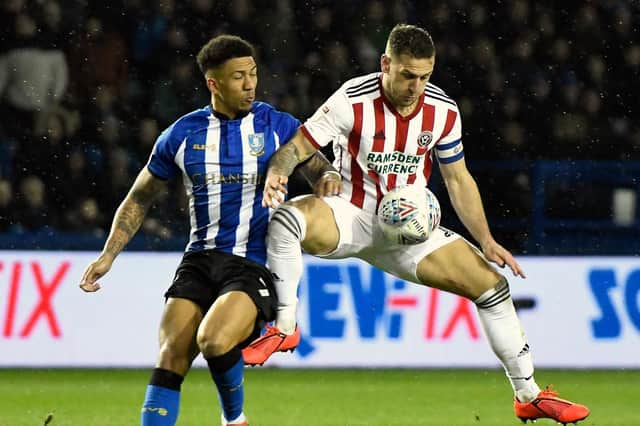 Billy Sharp of Sheffield United is challenged by Liam Palmer of Sheffield Wednesday  (Photo by George Wood/Getty Images)