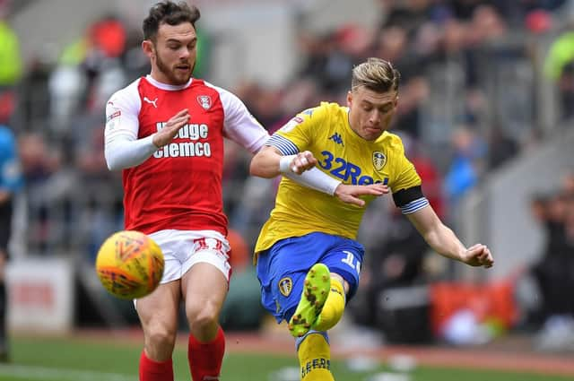 Leeds United's Tyler Roberts (right) battles with Rotherham United's Jon Taylor. Pic: Dave Howarth/PA Wire.