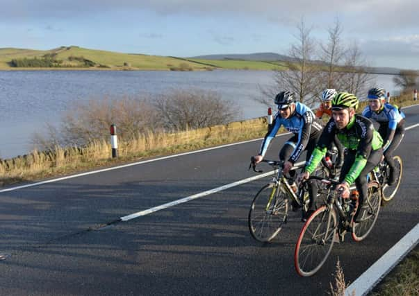 Cyclists pass Chelker reservoir between Addingham and Skipton which is used as part of this year's stage from Leeds to Harrogate.  Picture by Bruce Rollinson