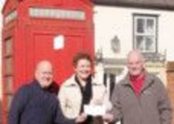 Councillor Hazel Brand is pictured handing over a cheque to Parish Council personnel, Dave Harford (left) and Peter Ray, which is to go towards a new information centre in West Stockwith.