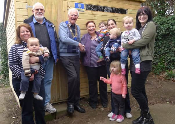 Pictured is Lions President Peter Lindley being thanked by playgroup leader Louise Lindsay, along with fellow Lion Albert Deakin, who helped install the equipment store, along with helpers, parents and toddlers who attend the group.