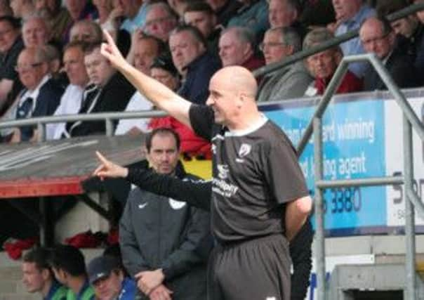 Manager Paul Smith gives his team directions during the second half