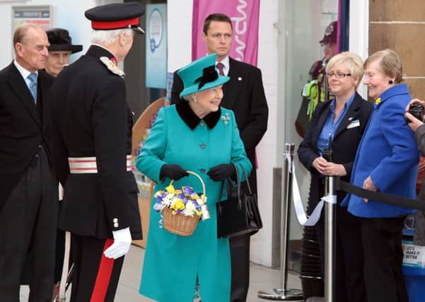 The Queen is greeted by the public at the station