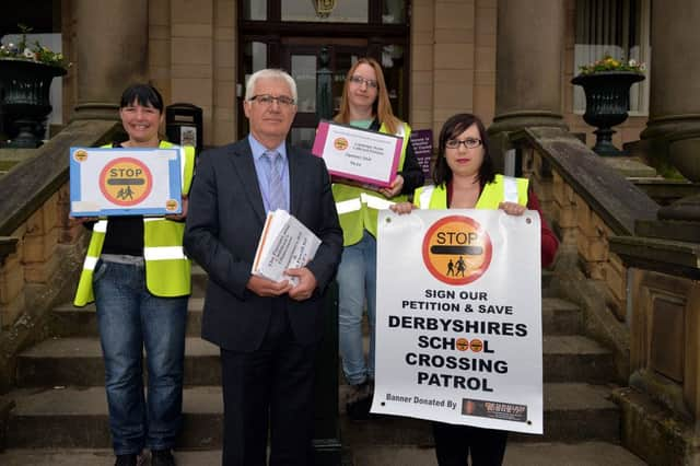 Lollipop lady Maxine Oliver, parents Emma McGwyre and Kelly Louise Stevens hand over the petition to the council's Mike Askworth.