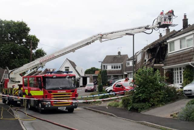 Fire crews at the house in Riddings, near Alfreton where two people died in a fierce house fire after a suspected gas blast. PRESS ASSOCIATION Photo. Picture date: Sunday September 20, 2015. See PA story FIRE Blast. Photo: Matthew Cooper/PA Wire