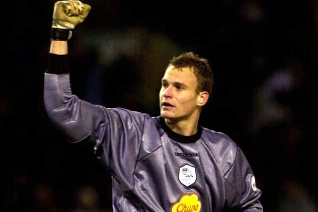 Owls Sub keeper Sean Roberts salutes a victory at Burnely