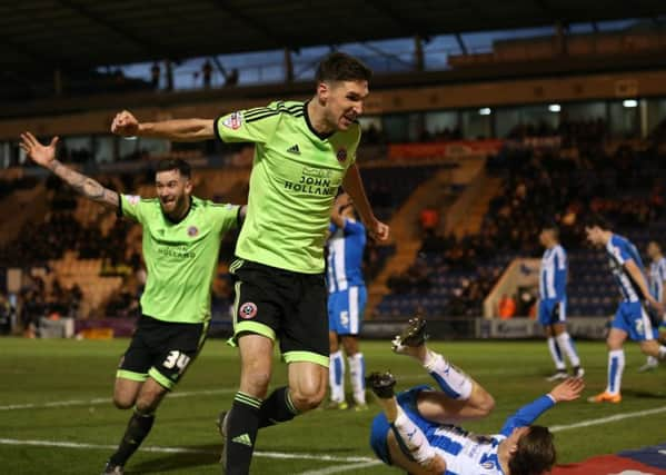 Sheffield United's Chris Basham celebrates the winner with scorer David Edgar. Photo:  Sport Image