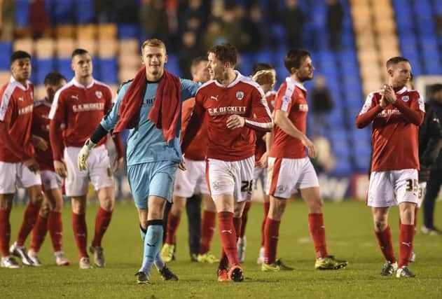 Barnsley penalty-save hero goalkeeper Adam Davies is all smiles with captain Alfie Mawson at full time. Photo: Dwean Atkins