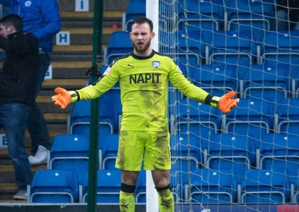 Chesterfield vs Peterborough United - Tommy Lee holds out his arms in frustration after feeling he was fouled before Tom Nichols scored for Peterborough - Pic By James Williamson