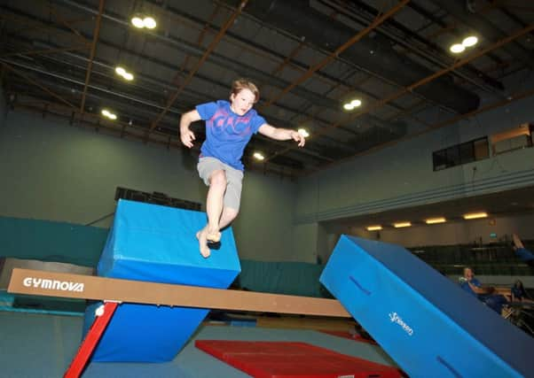 Alex Bourne, 13, has become hooked on freestyle gymnastic sessions held at Hillsborough Leisure Centre. Alex is pictured with coach Iain Simpson-Banks.