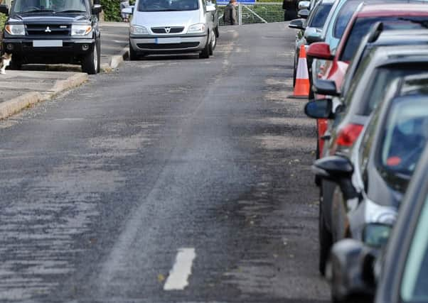 Parking troubles outside Oughtibridge Primary School, Naylor Road, which is causing parents with prams to walk on the road. Picture: Andrew Roe