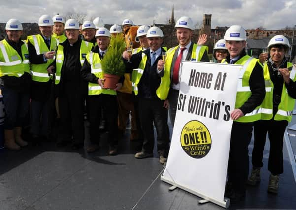 Glasses are raised at a topping out ceremony for the new residential centre created by St Wilfrid's. Picture: Andrew Roe