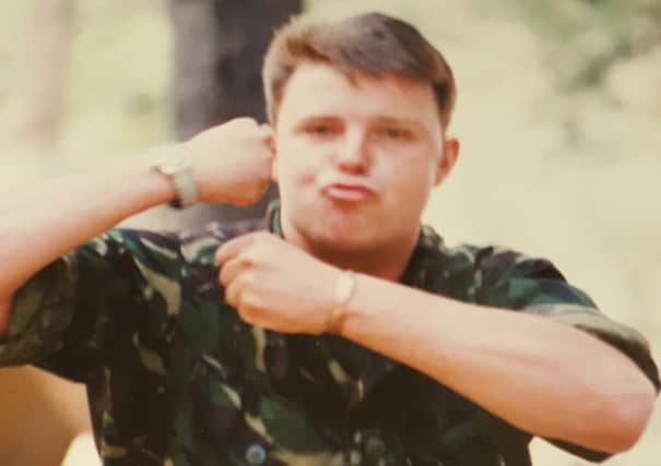 War hero Stephen Marklew flexes his muscles for the camera.