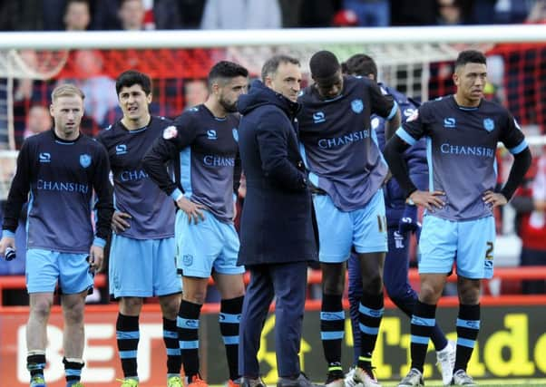 Owls head coach Carlos Carvalhal holds an inquest with his players pn the pitch after the final whistle