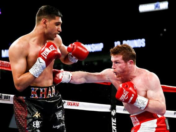 Khan in trouble against Alvarez