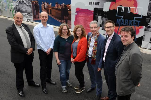 (l-r) Steve Mettam, Martin Gorman, Cora Glasser, Rachael Dodd, Simon Ogden, Cllr Leigh Bramall and David Clarke infront of the artwork around the site of Sheffield Castle. Picture: Andrew Roe