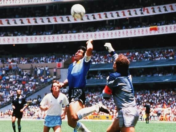 Diego Maradona scoring the 'Hand of God' goal -