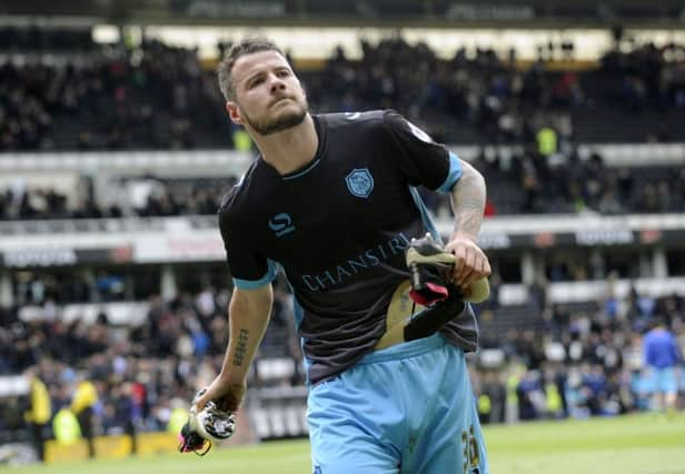 Owls Daniel Pudil throws his boots into the crowd at the final whistle...Pic Steve Ellis