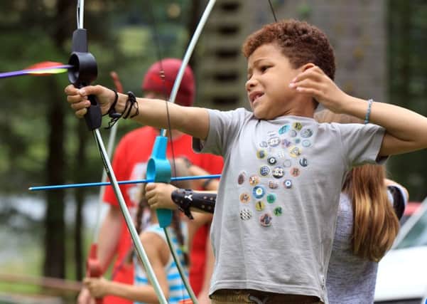 Outdoor have a go taster sessions for the summer holidays at Underbank Reservoir Activity Centre near Sheffield. Joel Mckenzie, seven, having a go at archery.