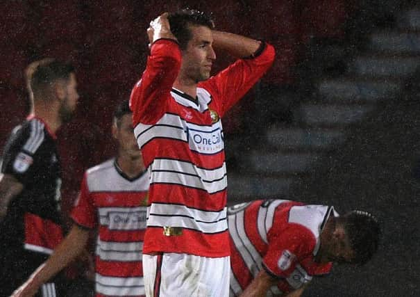 Matty Blair puts his head in his hands after Rovers concede a late goal to exit the EFL Cup at the hands of Nottingham Forest