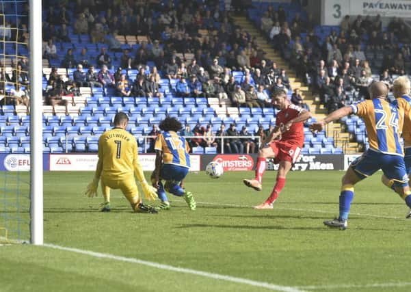 Shrewsbury Town's Junior Brown brings down Chesterfield's Gboly Ariyibi