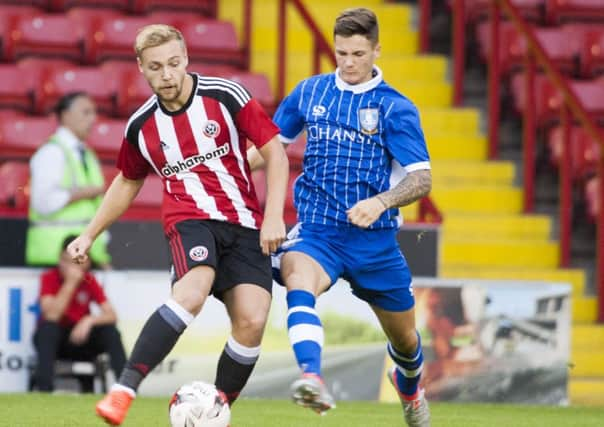 Harry Chapman (left) puts Sheffield Wednesday's defence on the back foot