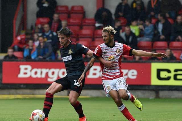 Rovers' Jordon Houghton challenged by  Crewe's Alex Kiwomya