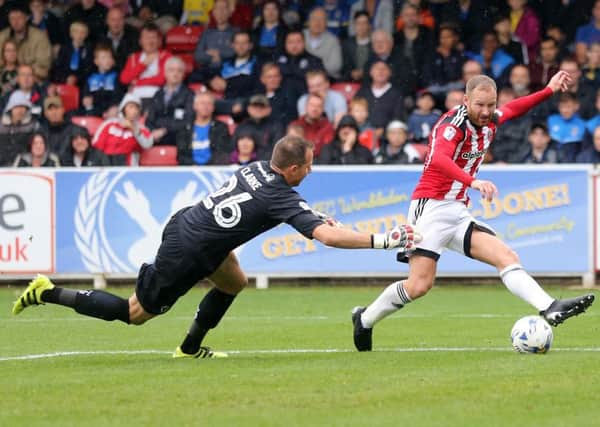 Sheffield United's Matt Done slots home the third at Wimbledon