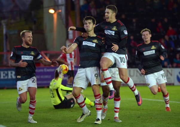 John Marquis is mobbed by team mates as he celebrates giving Rovers the lead