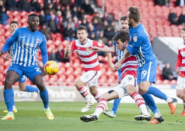 John Marquis battles for possession.