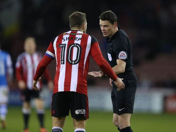 Referee Darren England has a word with Sheffield United's Billy Sharp