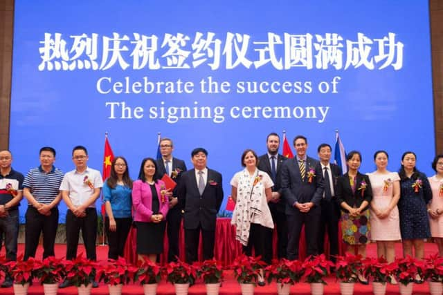 Sheffield Council leader Julie Dore signs a 60-year deal with Chinese firm Sichuan Guodong Construction Group.