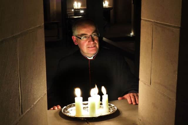 Advent at Sheffield Cathedral: Canon Keith Farrow talking to a colleague  through one of the crypt windows