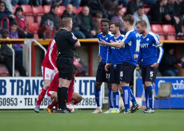 Swindon Town vs Chesterfield - Chesterfield players surround referee Trevor Kettle after sending off Charlie Raglan for a second bookable offence - Pic By James Williamson