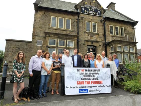 Protesters, who won their fight to prevent The Plough becoming a Sainsbury's,  outside the pub