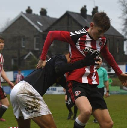 Sheffield United U23's David Brooks fends off Barnsley U23's Romal Palmer.