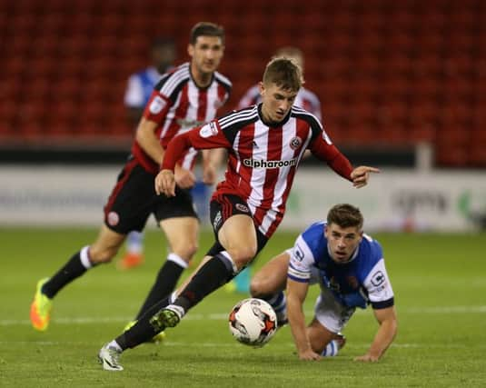 David Brooks of Sheffield Utd leaves Joe Edwards of Walsall during the Checkatrade Trophy match at Bramall Lane Stadium, Sheffield.  Pic Simon Bellis/Sportimage