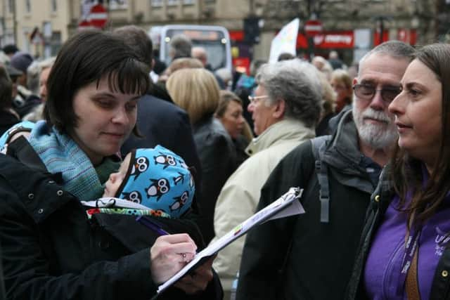 A woman signs the 'Save Hurlfield View' petition