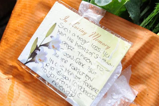 A floral tribute left close to the flat in which Craig Wild was found stabbed to death