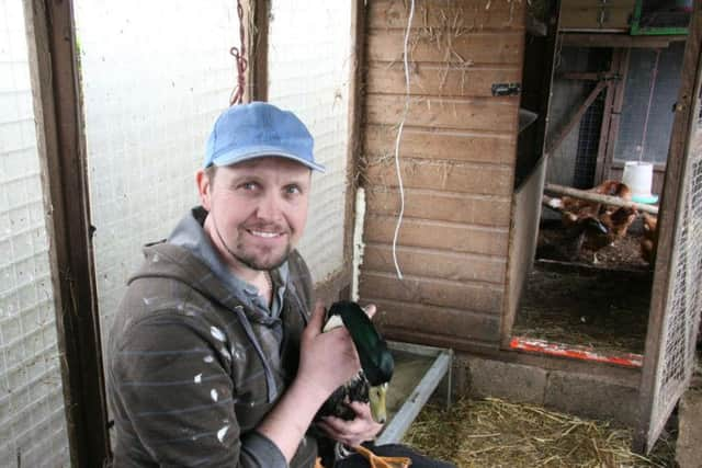 Jason Seymour with the poultry he keeps on his plot at Stubbin Allotments