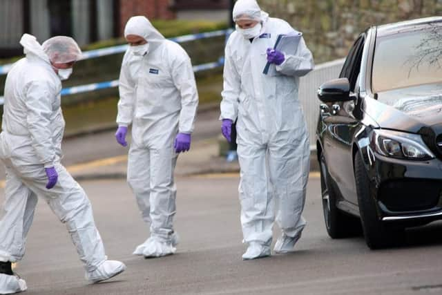 Forensics officers investigate the scene of the fatal shooting (Glenn Ashley)