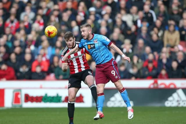 Sheffield United's Jack OConnell tussles with Scunthorpe's Paddy Madden