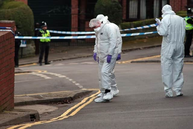 Forensic investigators at the scene in Daniel Hill.