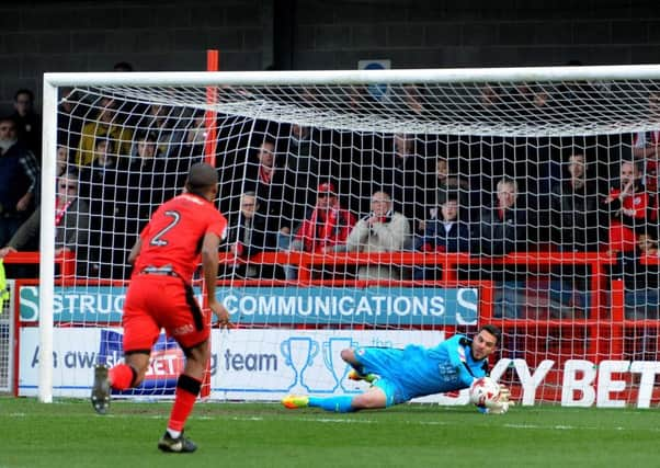 Crawley keeper Glenn Morris beats away John Marquis penalty. Picture: Steve Robard.