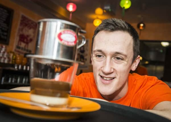 Jim Rose with a drip filter coffee at Nm SÃ´ng, the new Vietnamese coffee house in Broomhill  the coffee falls on to condensed milk in the cup